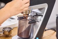 A person operates the Baratza Sette 270 Conical Burr Grinder