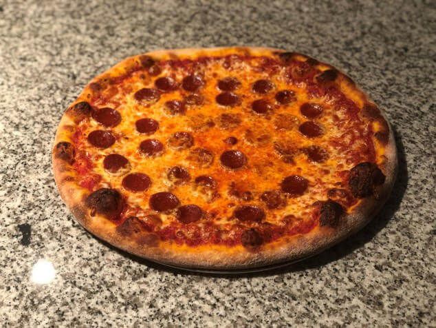 Overhead view of a pepperoni pizza on a counter