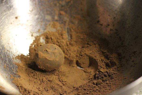 rolling truffles in cocoa powder