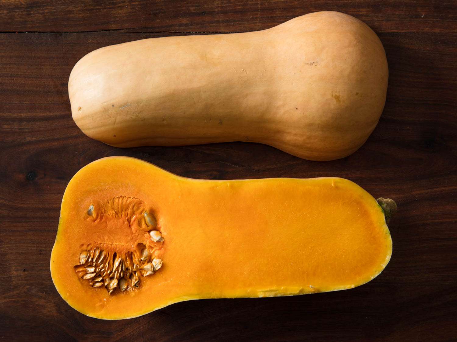 Butternut squash halved and displayed cut side down and cut side up