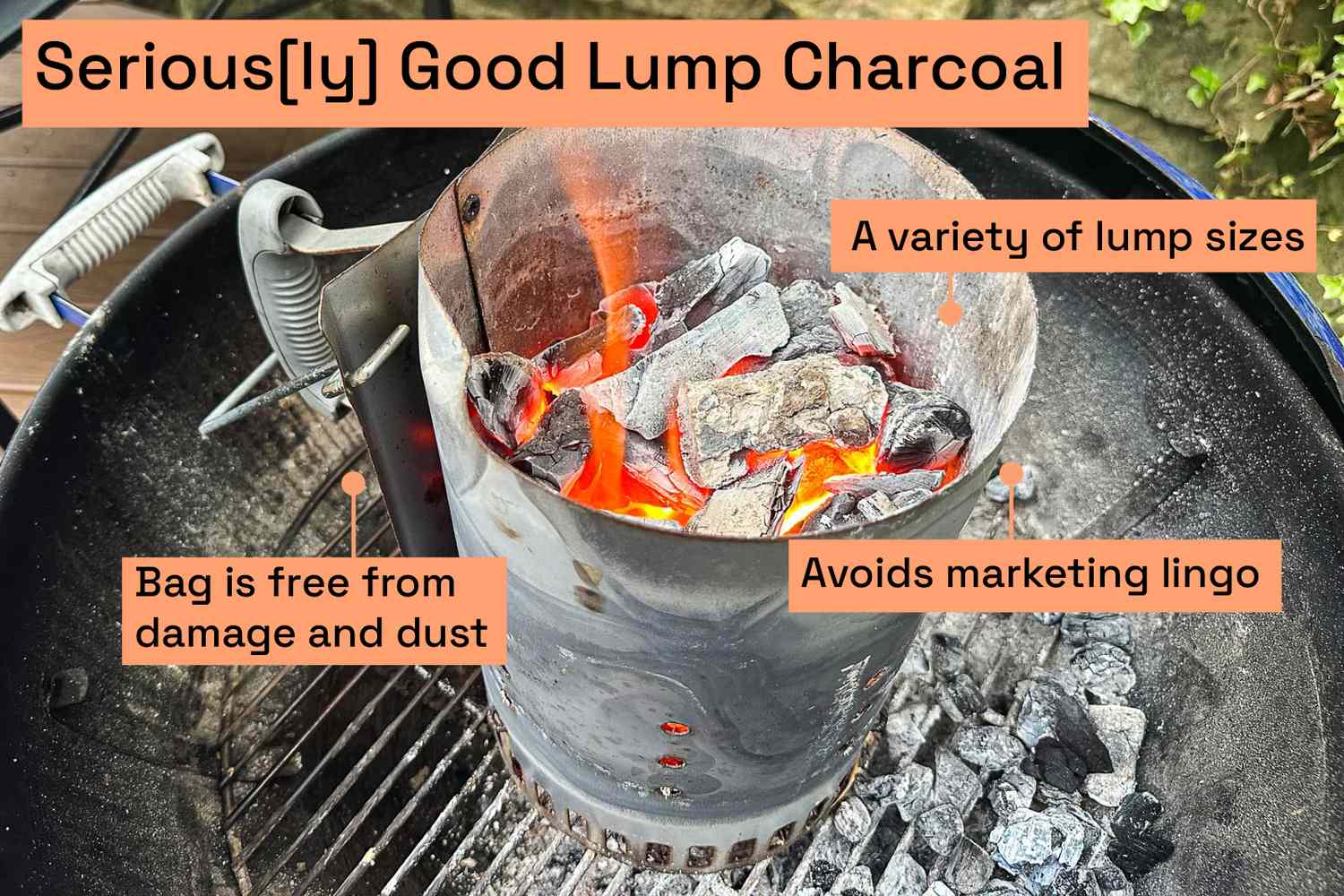A charcoal chimney full of lit lump charcoal sitting on top of a kettle grill