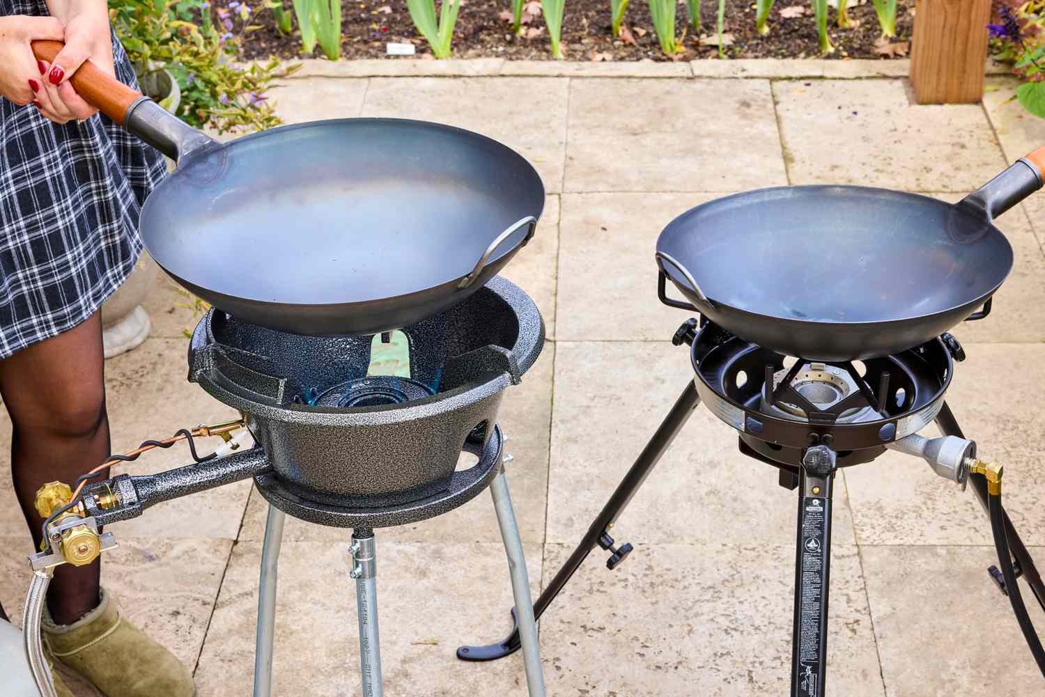 Two outdoor wok burners on a patio.