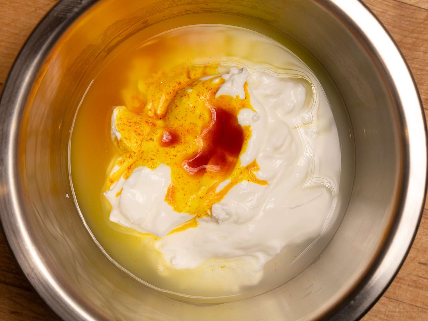 yogurt, saffron and rosewater in a bowl together 