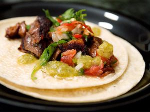 A pork stomach taco with tomatillo salsa