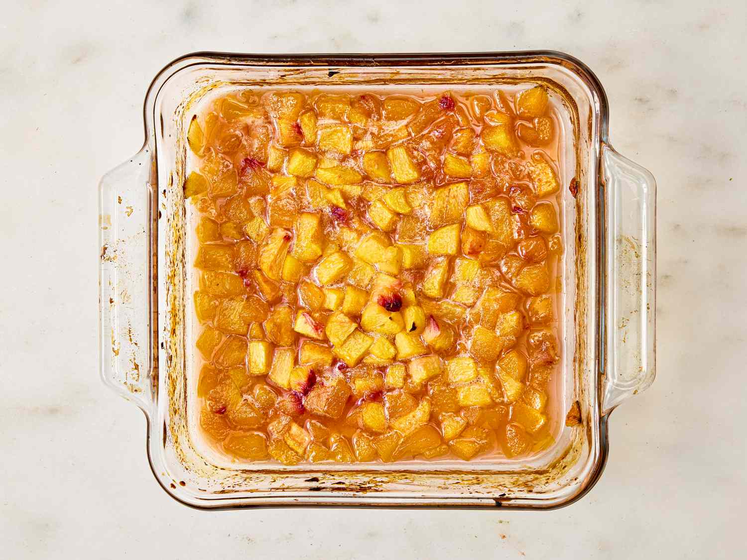 Baked diced peaches in a square glass dish