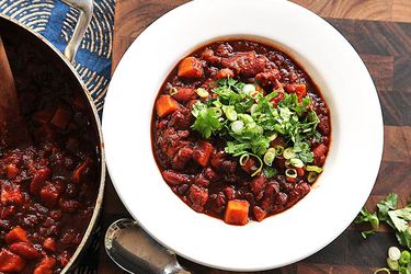 Overhead view of a bowl of vegan sweet potato and 2-bean chili with hominy.