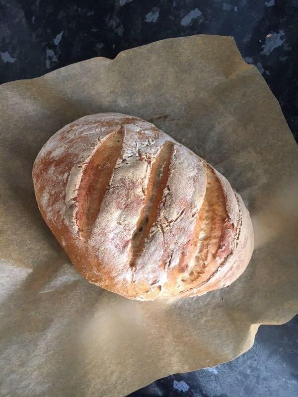 Overhead view of a loaf of bread on parchment paper