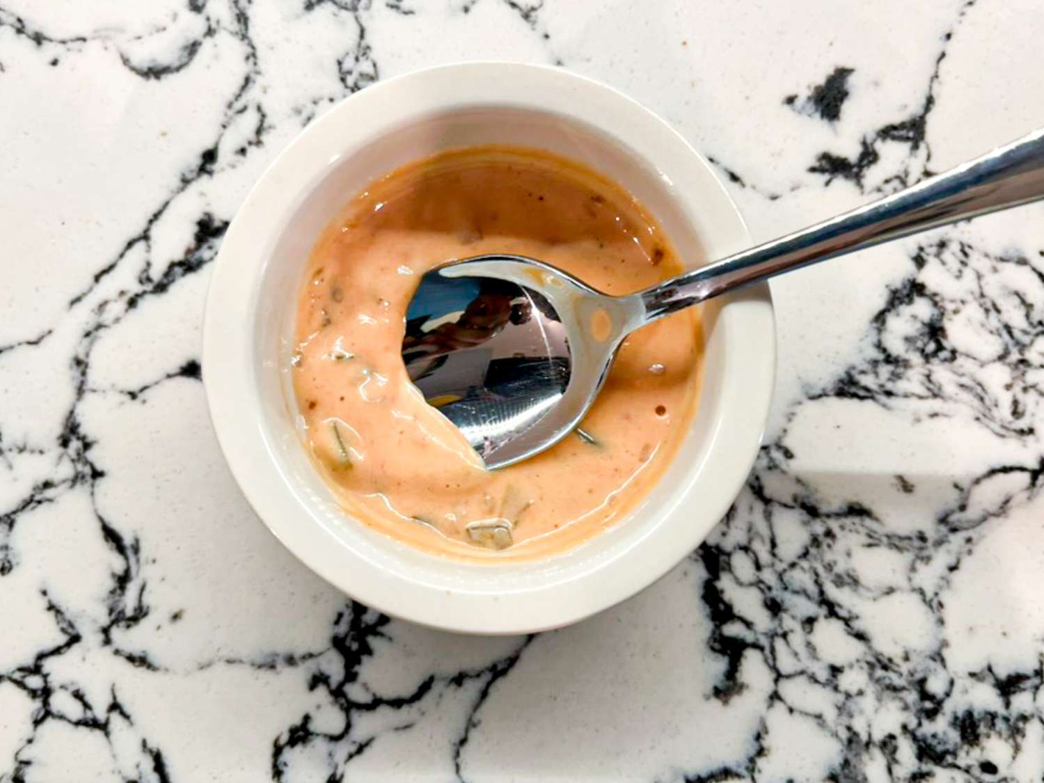 Special sauce in a small ramekin with a spoon