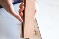 A person holding the King Whetstone sharpening set