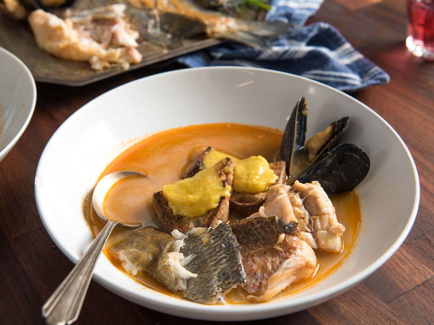 Close up of a serving of bouillabaisse at the table.