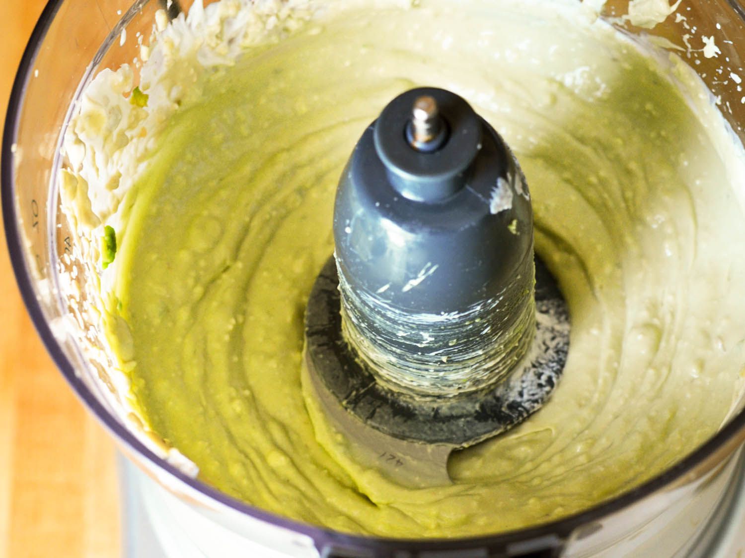 Avocado blue cheese dip being pureed in a food processor.