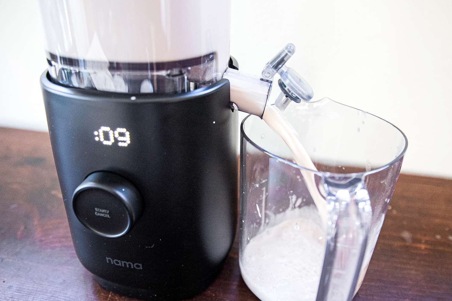 the nama dispensing milk into a container