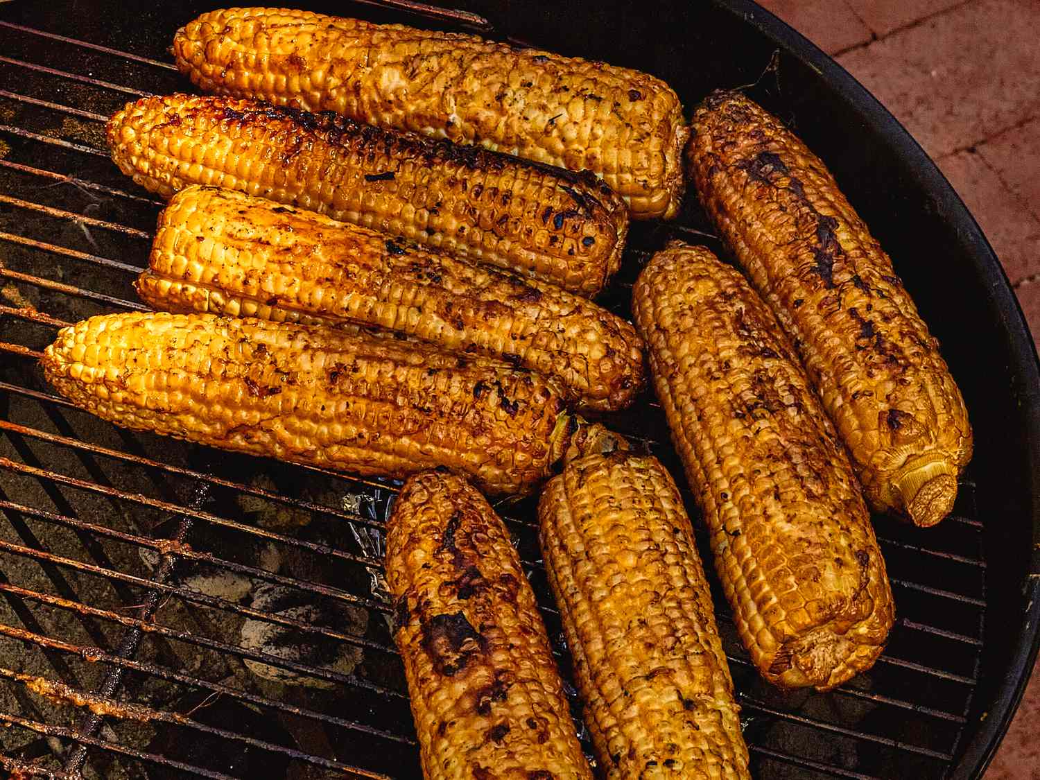 Grilled corn cooking on a barbecue grill
