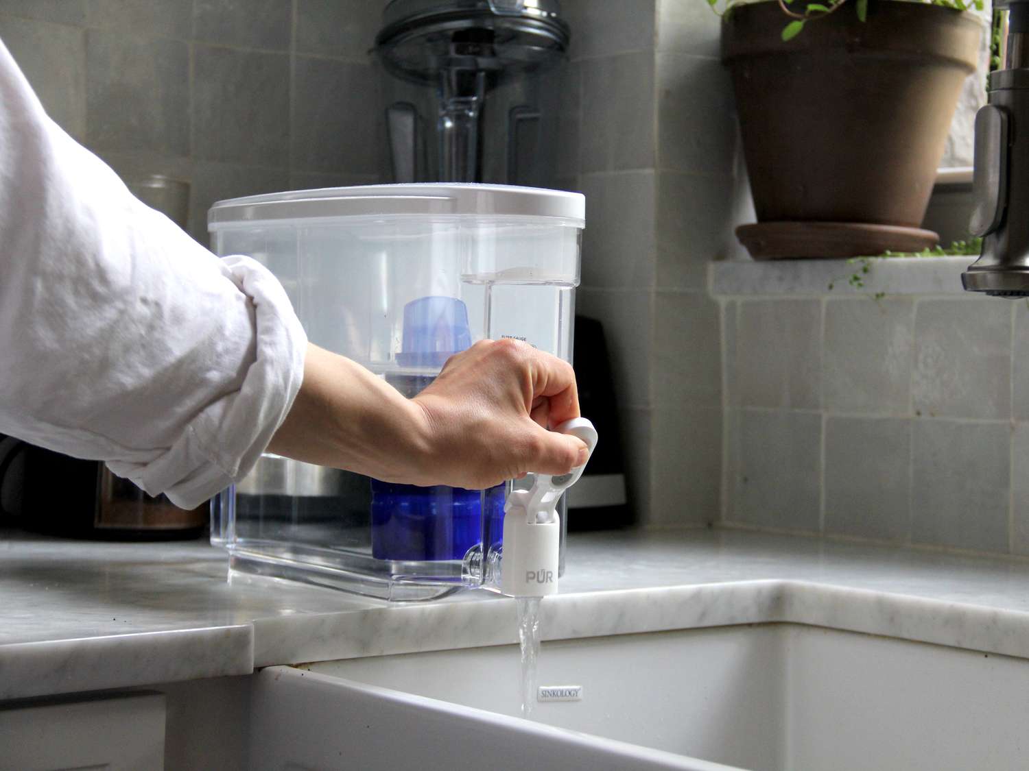a person dispensing water from the Pur dispenser