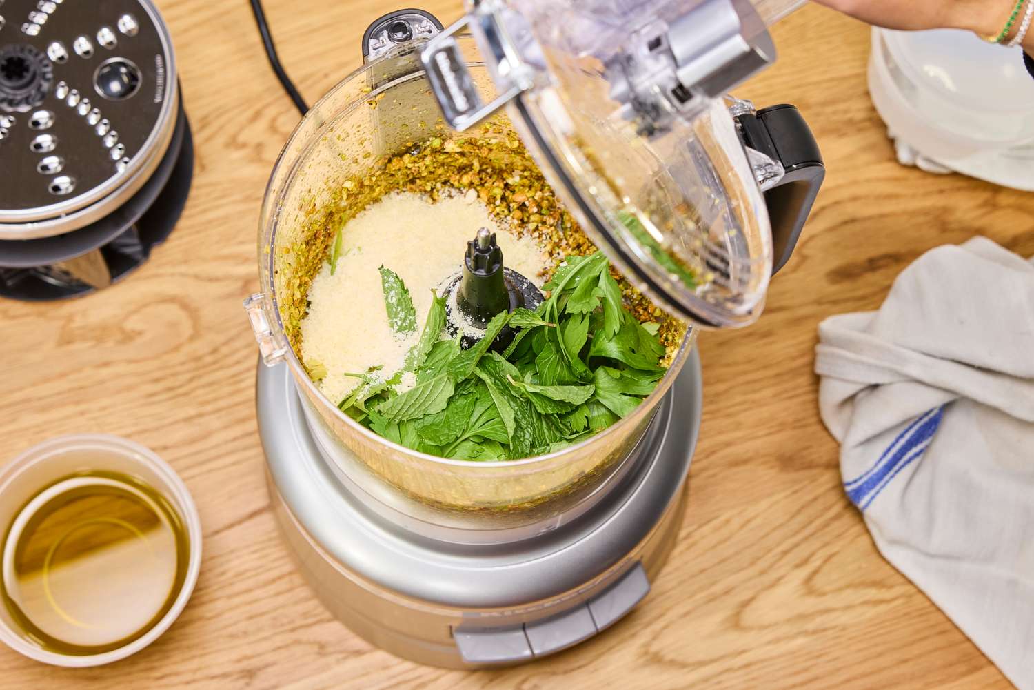 Pesto ingredients inside the KitchenAid 13-Cup Food Processor