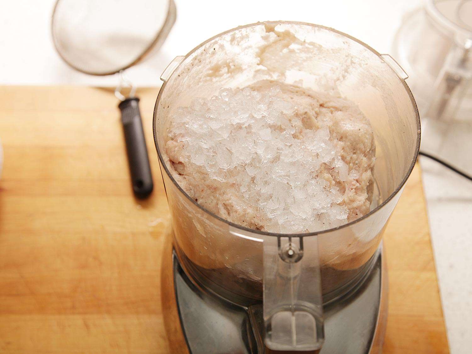 Crushed ice has been added to the food processor.