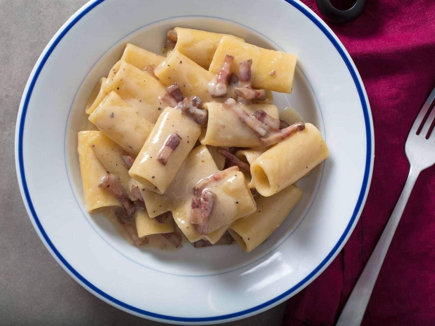 a plate of pasta with a fork beside it