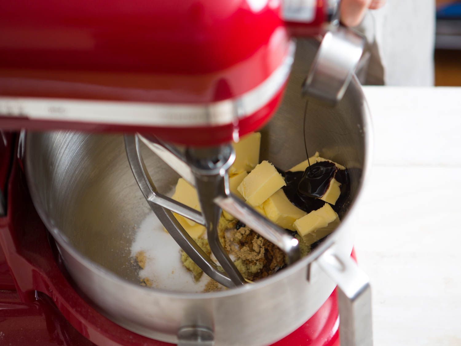 Creaming butter, sugar, and molasses together in the bowl of a stand mixer.