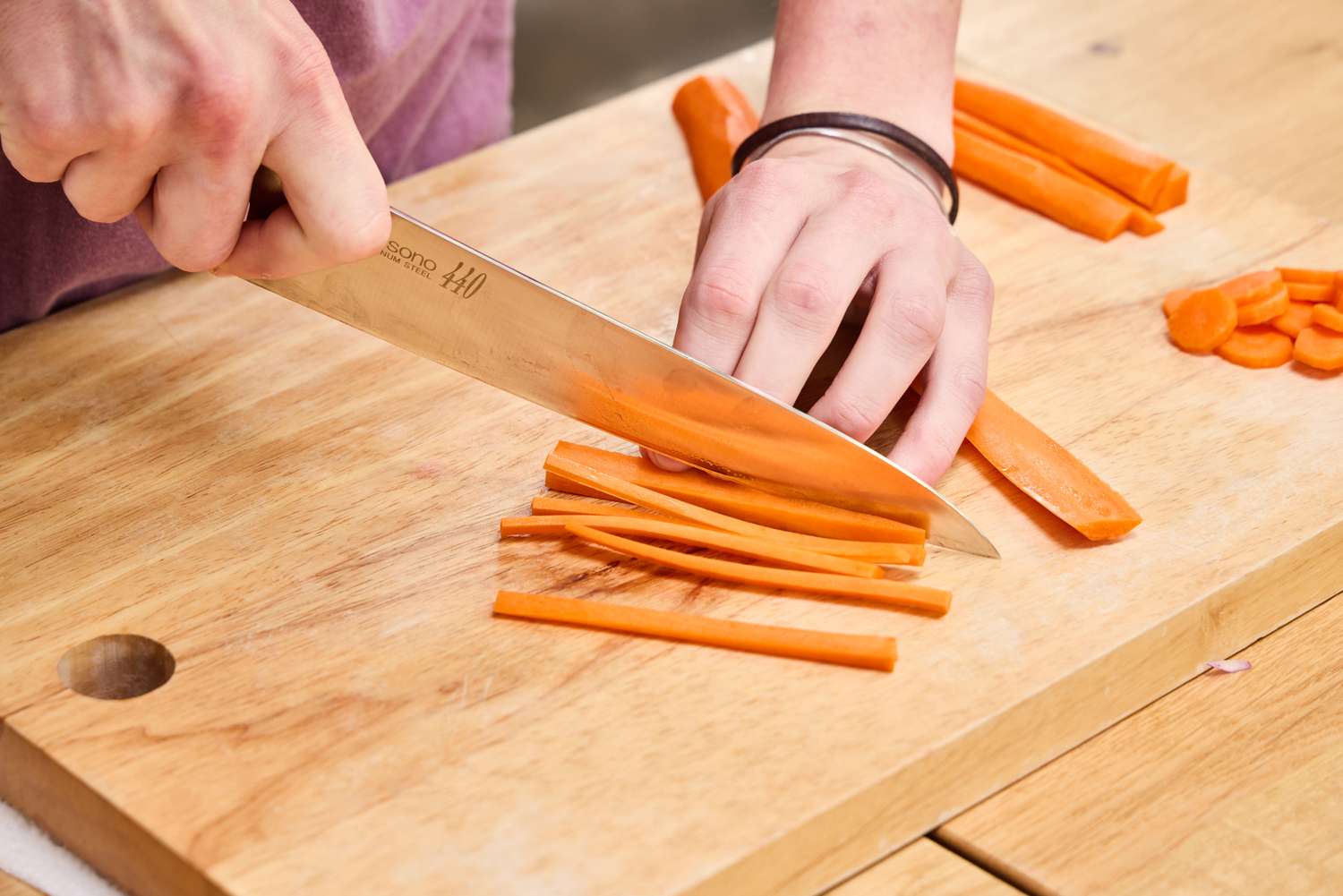 A person slices carrots using the Misono 8.2 Inch Molybdenum Gyutou