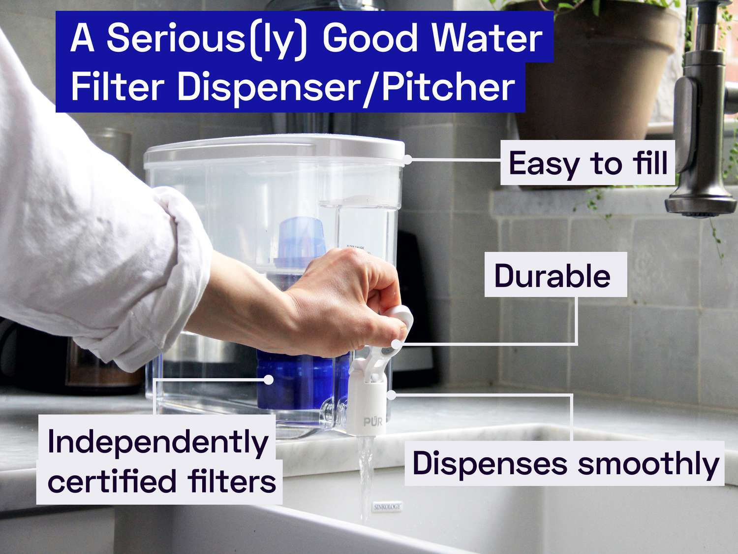 a hand pressing the tab on the Pur water dispenser releasing water into the sink