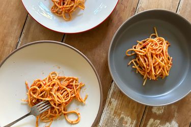An overhead shot of three pasta bowls filled with spaghetti.