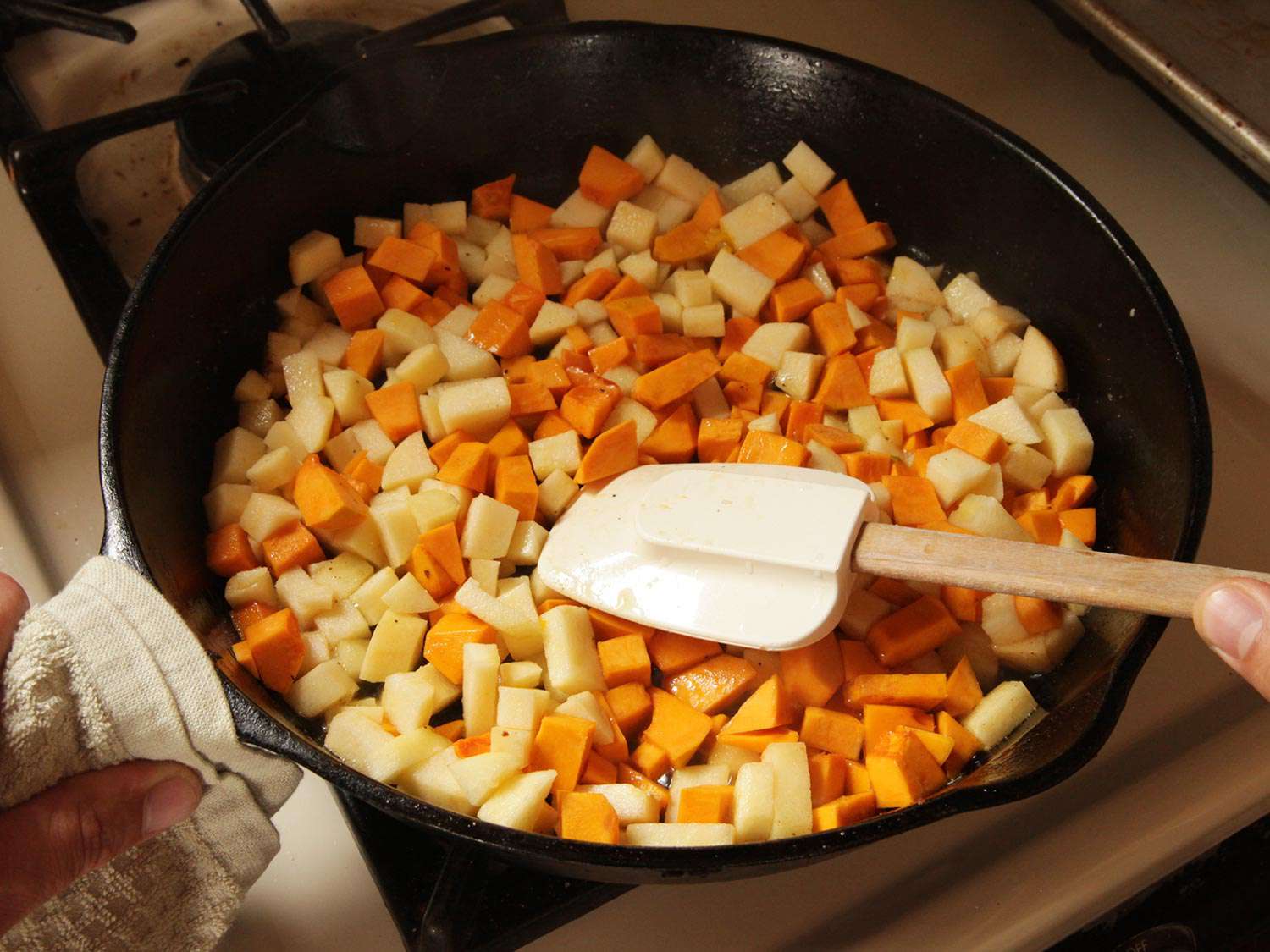 Sauteing diced apple and squash a in cast-iron skillet.