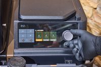 A person adjusts a dial on the Traeger Ironwood XL