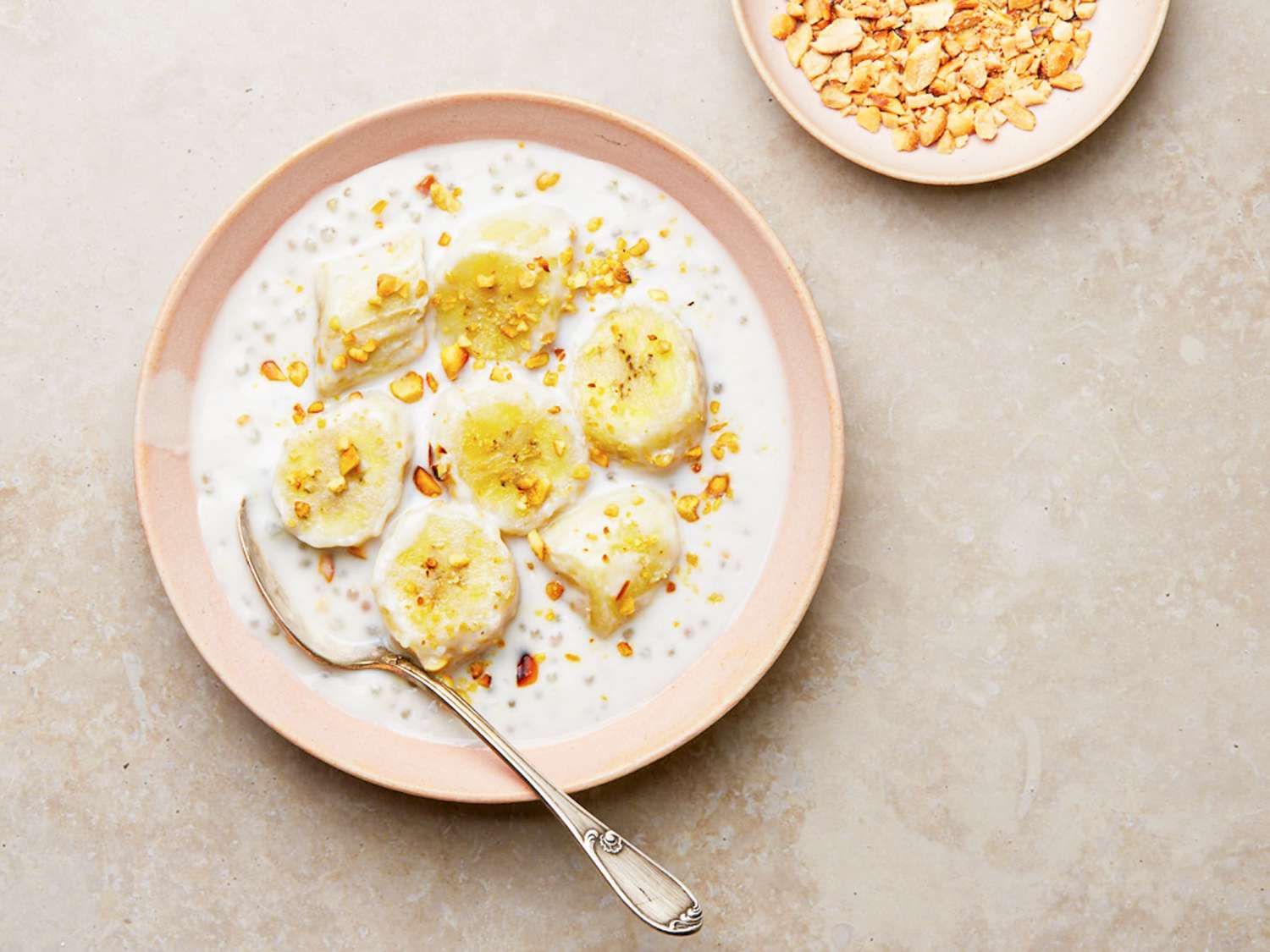 Overhead view of finished che with a spoon and a side bowl of peanuts