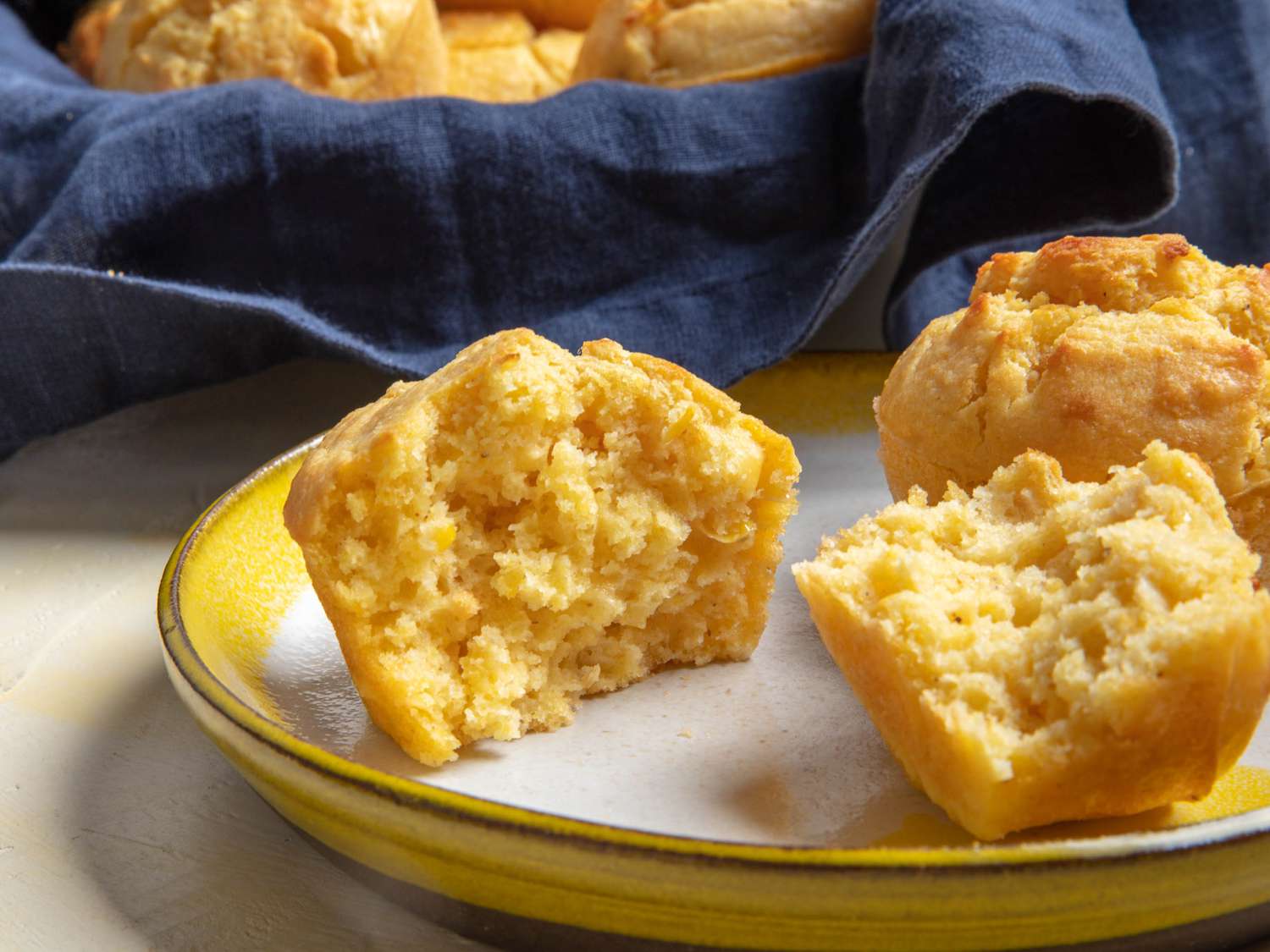 Cornbread muffins split in half on a plate