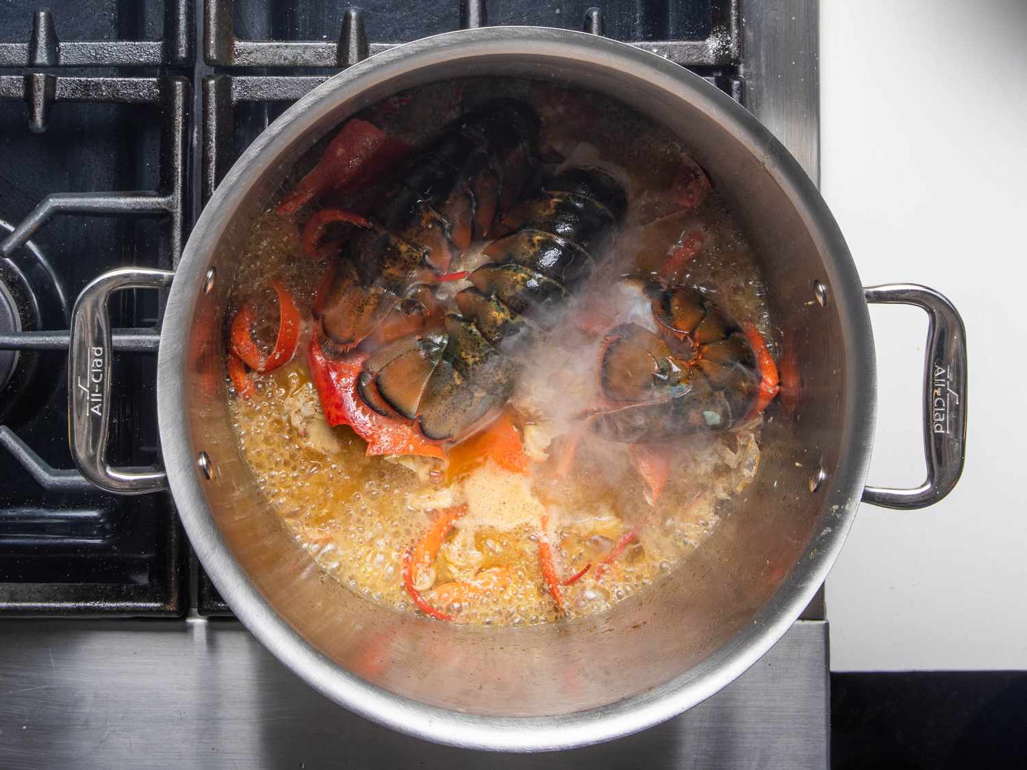 Tails go on top of the shells in the pot to be steamed.