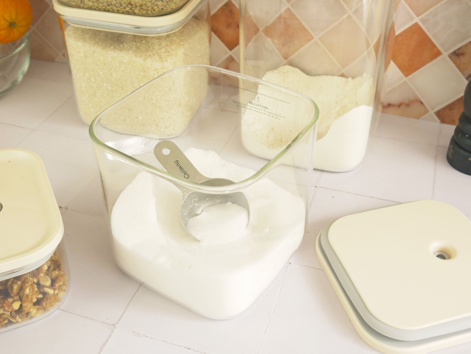 the scoop inside a container with sugar