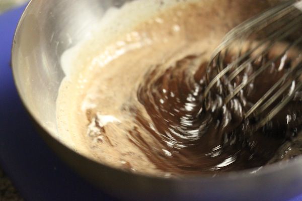 whisking together chocolate and cream