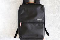 A Chef Sac backpack displayed on a light surface featuring a clean and minimalist design with a logo and front pocket