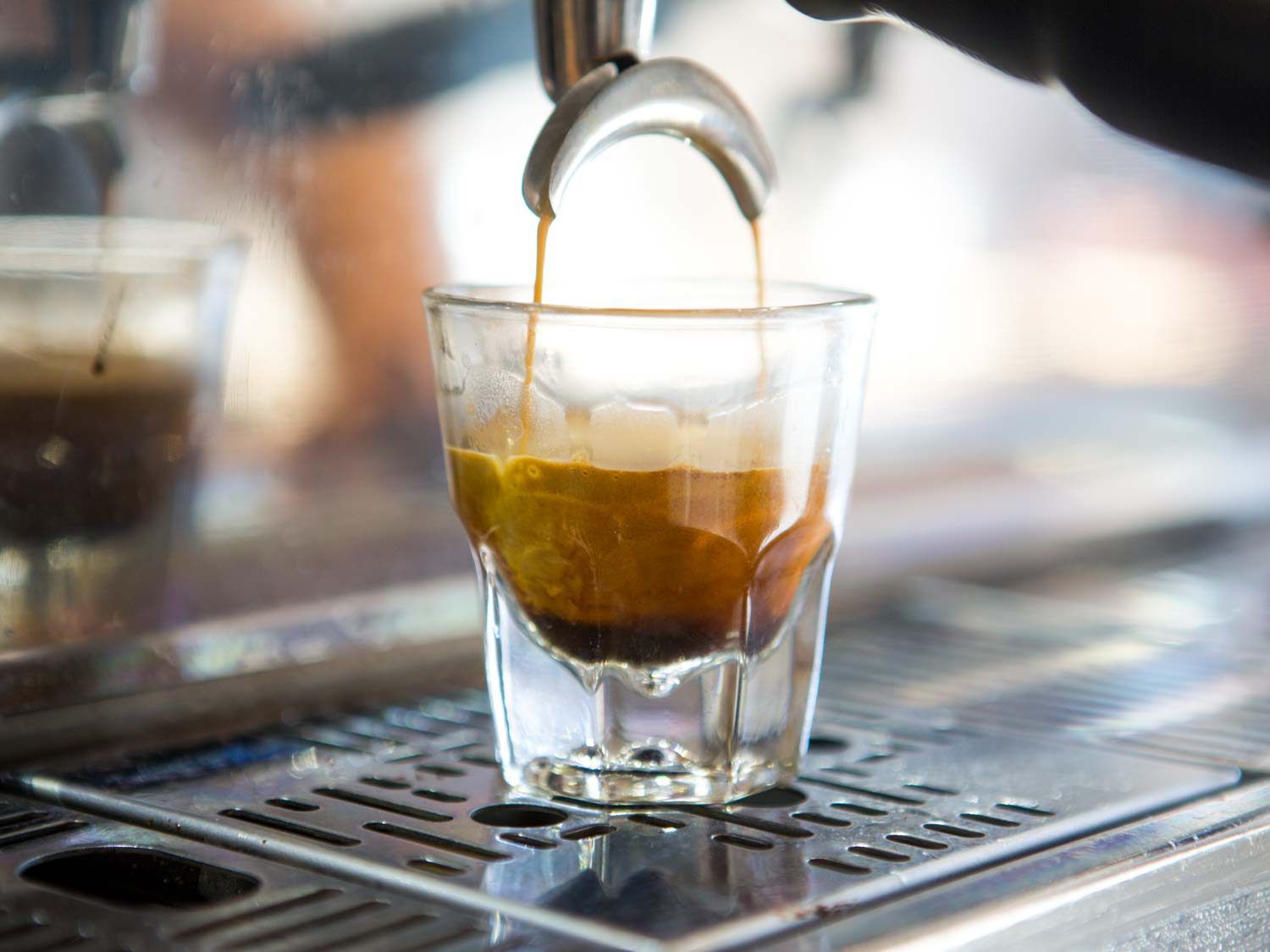 Espresso pouring into a small shot glass