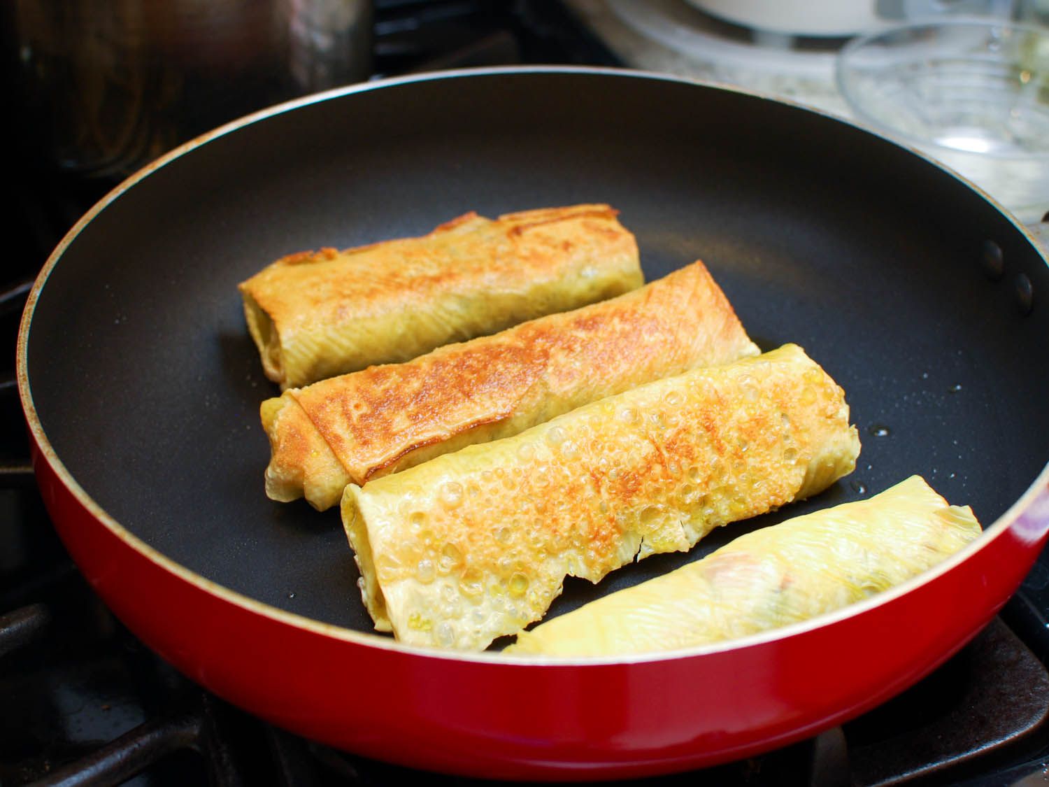 The filled rolls of beancurd are browned on all sides in a nonstick skillet.