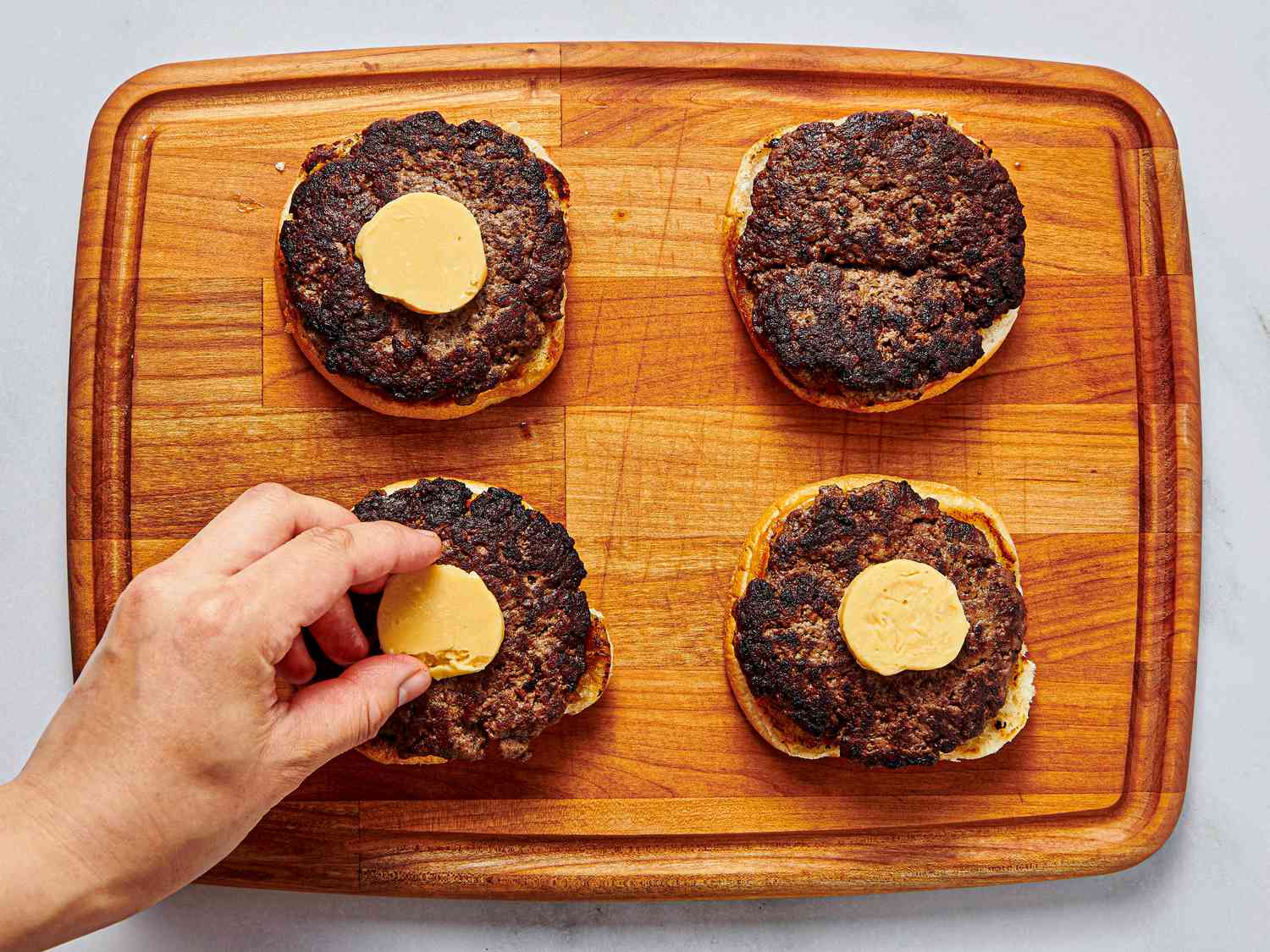 Overhead view of butter on burgers