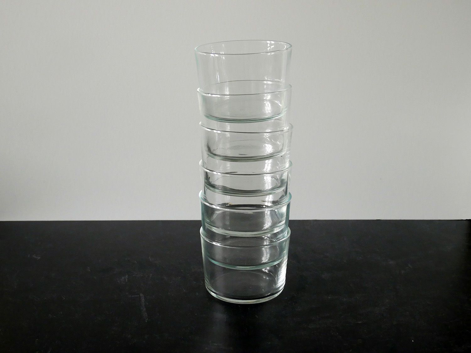 bodega glasses stacked up on a black countertop