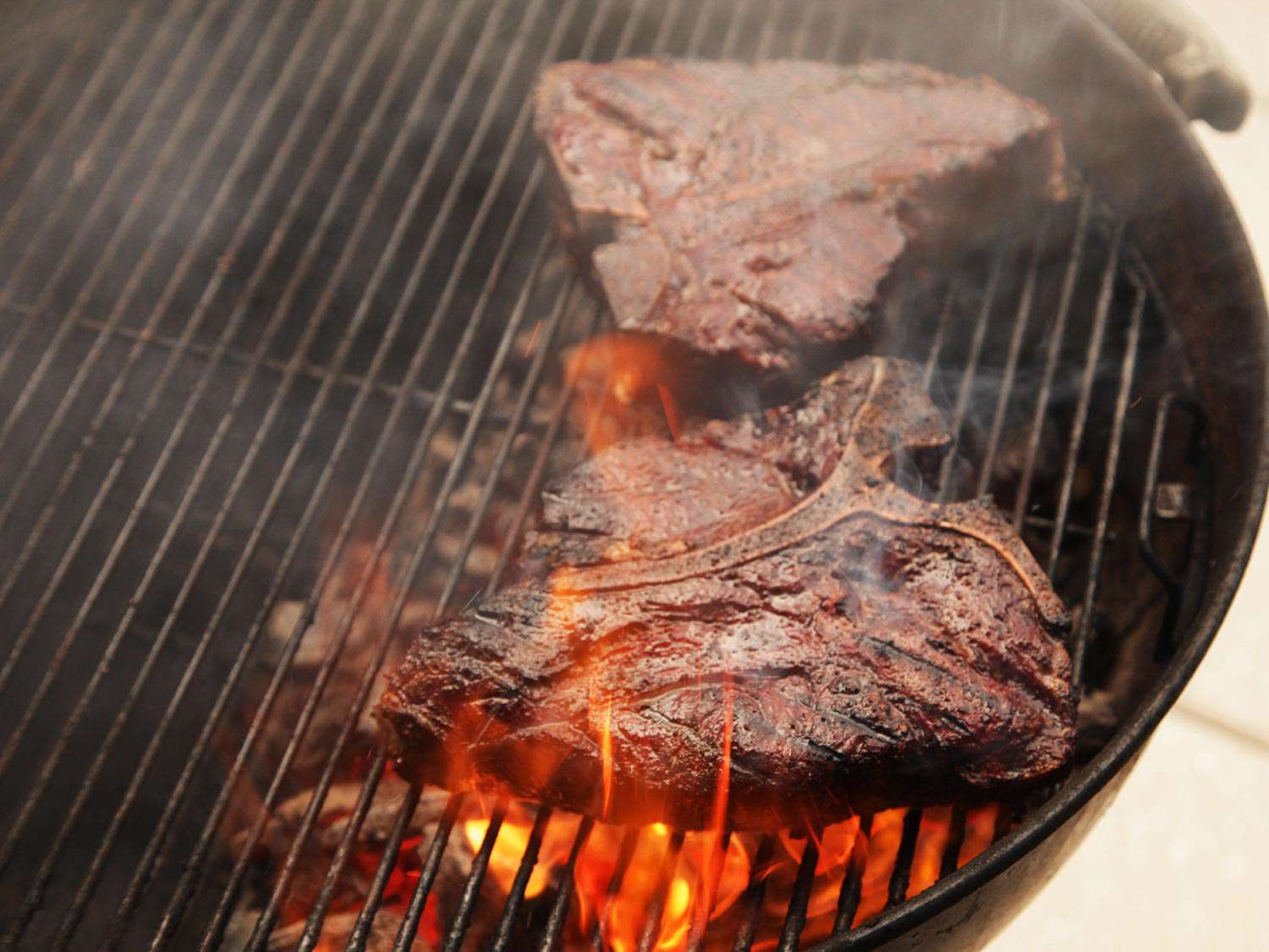 Grilling T-bone steaks on a hot grill.