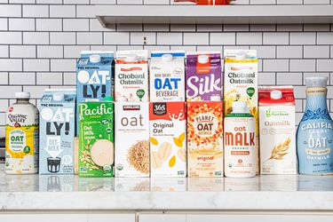 A selection of various oat milk brands displayed on a counter