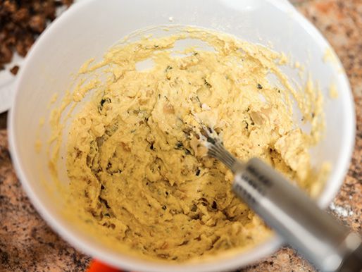 Whisking together fritter batter .