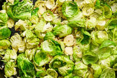 Cooked brussels sprouts sliced and arranged on a pan
