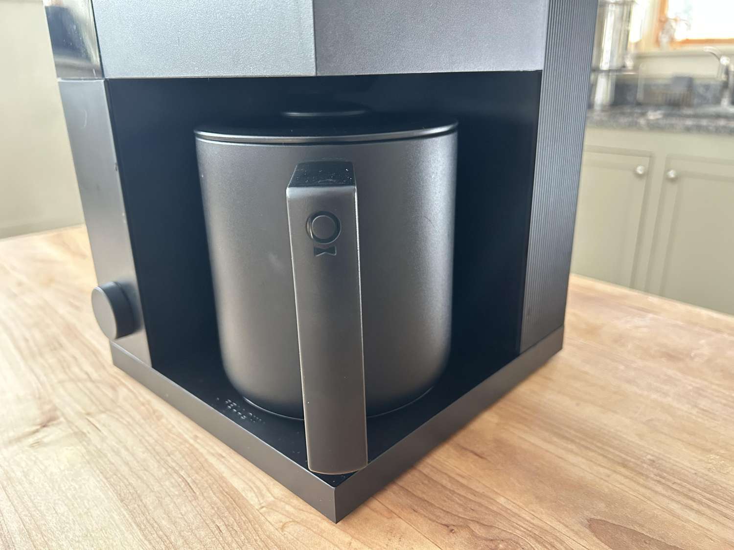 A closeup of the Fellow Aiden coffee maker's thermal carafe.