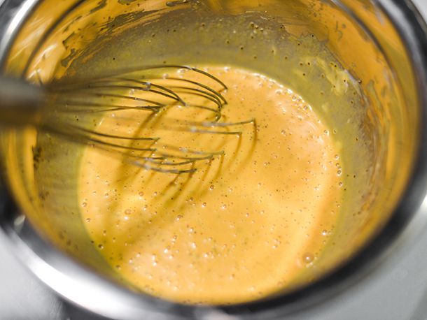 Whisking the mustardy coleslaw dressing.