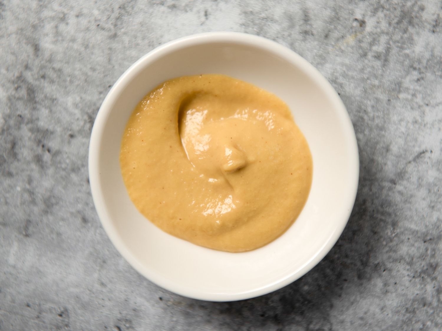 Dijon mustard in a small white bowl
