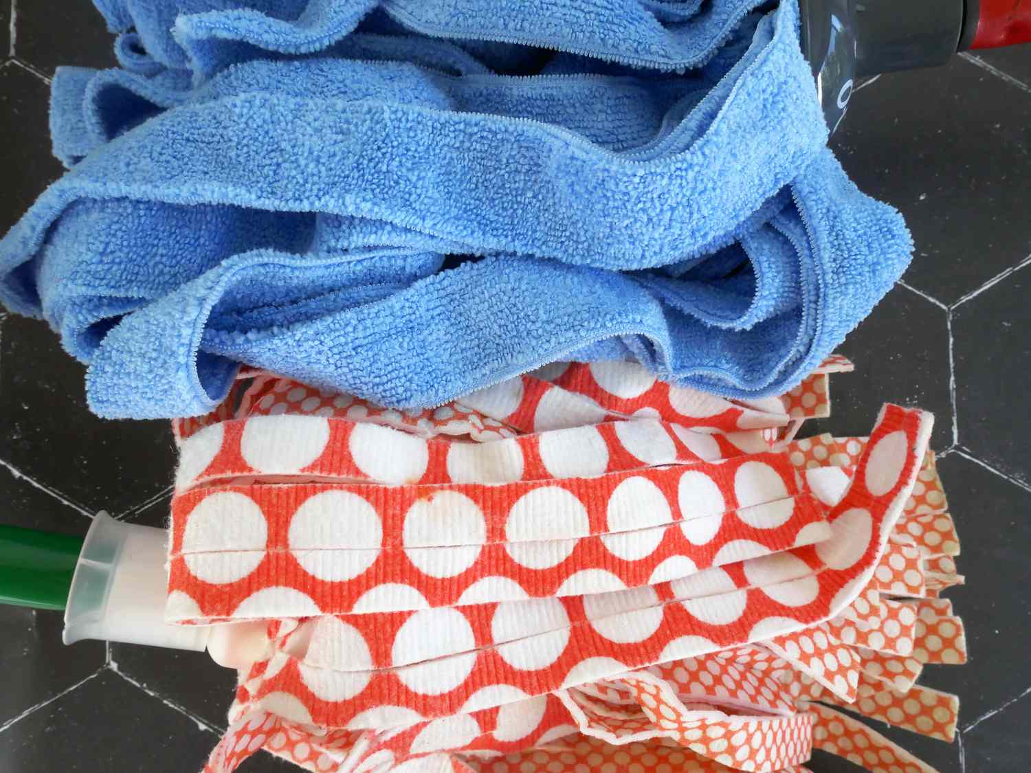 a lush, plush mop head next to a more plasticky, less absorbent one