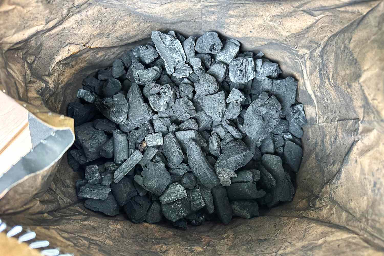 A bag containing The Good Charcoal Company Premium Hardwood Lump Charcoal pieces