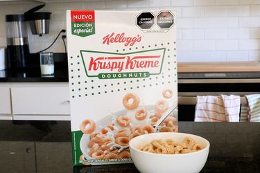 Box of Krispy Kreme cereal next to a bowl of the cereal 