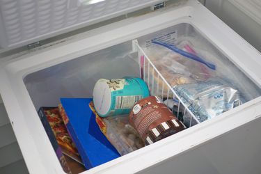 a chest freezer with the lid open revealing what's inside 