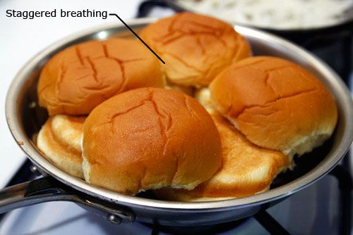 Slider buns arranged cut side-down over the patties. Top bun halves are staggered over the gaps left by bottom buns.