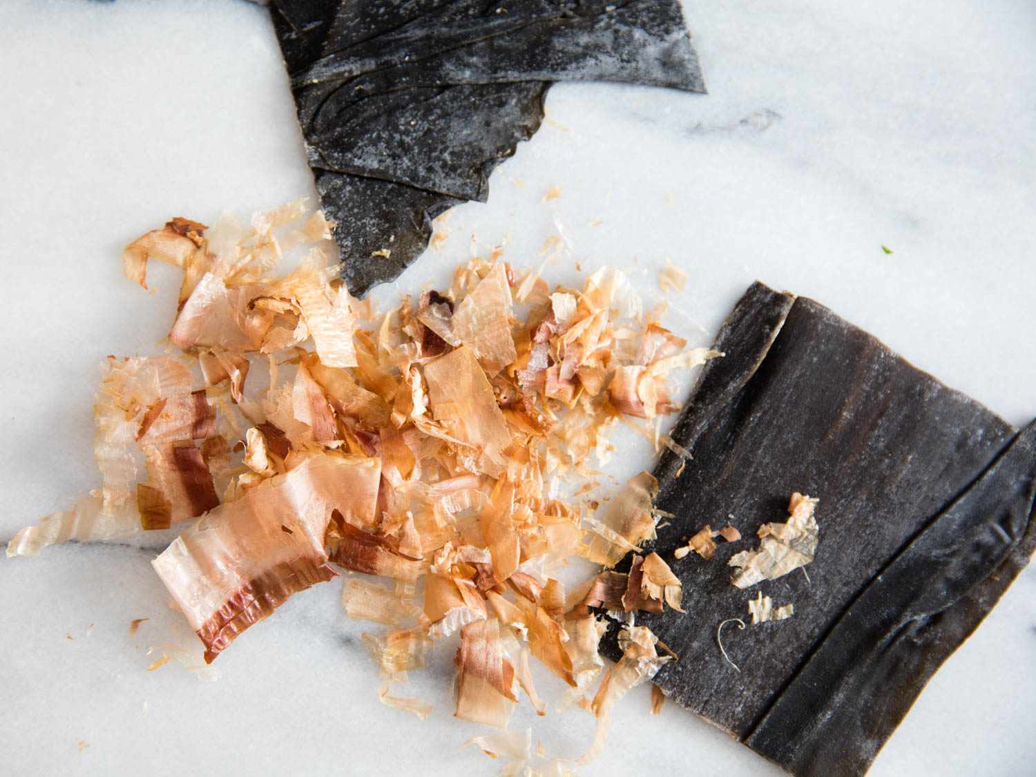Dry miso soup ingredients on a marble surface.